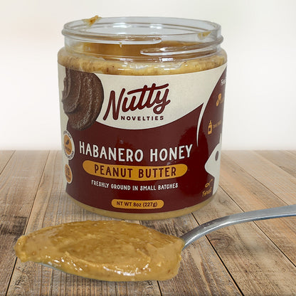 Habanero Honey Peanut Butter with spoon full of peanut butter in front of container