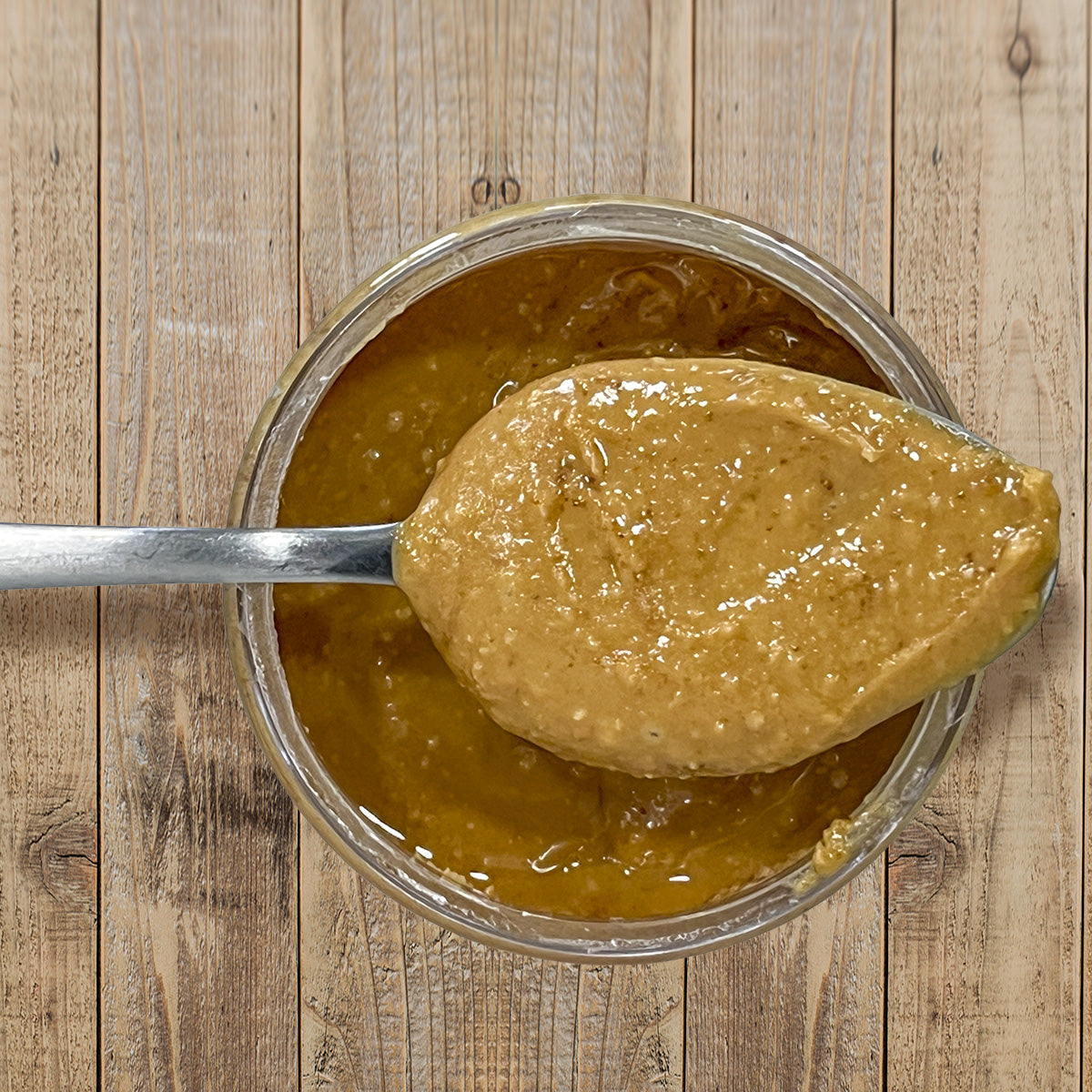 Habanero Honey Peanut Butter top view of open container with spoon full of peanut butter