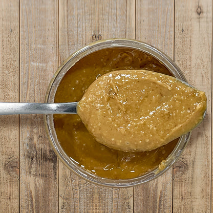 Habanero Honey Peanut Butter top view of open container with spoon full of peanut butter